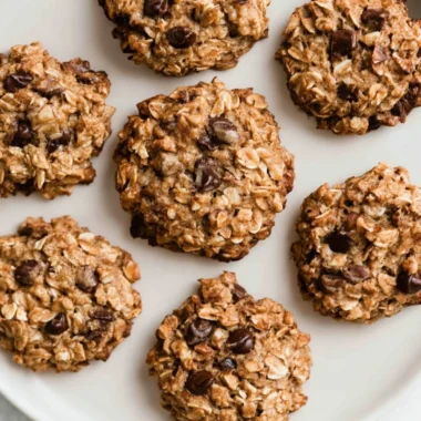 Freshly baked chocolate chip banana oatmeal cookies on a cooling rack