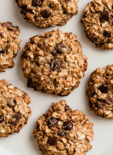 Freshly baked chocolate chip banana oatmeal cookies on a cooling rack