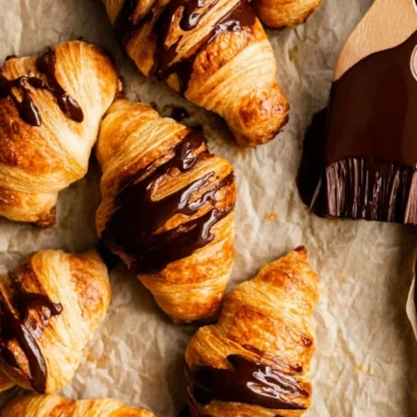 Freshly baked chocolate croissants with melted chocolate filling