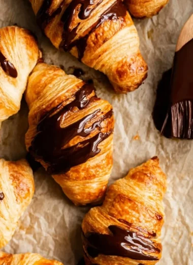 Freshly baked chocolate croissants with melted chocolate filling
