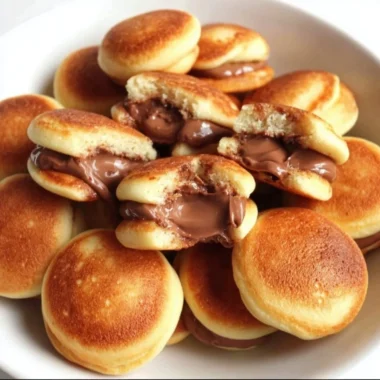 Stack of fluffy pancakes with syrup and berries