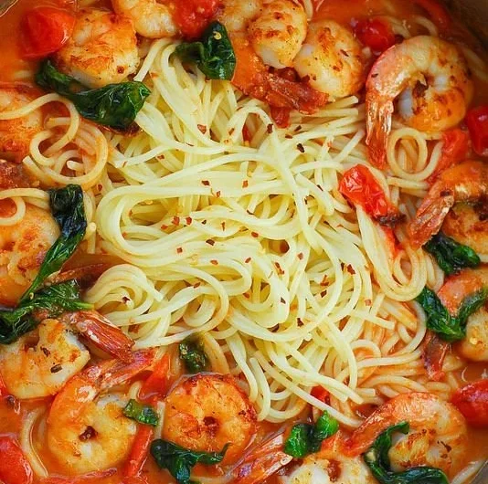 Shrimp pasta with garlic basil tomato sauce served in a bowl