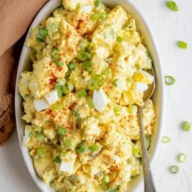 Delicious Southern Potato Salad served in a bowl with herbs and spices.