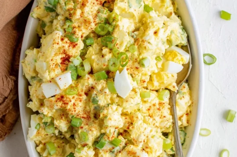 Delicious Southern Potato Salad served in a bowl with herbs and spices.