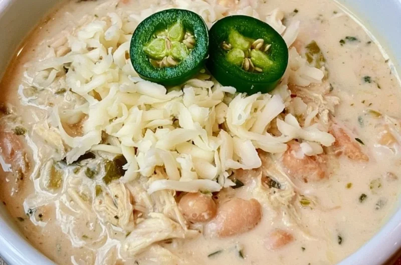 Delicious bowl of white chicken chili garnished with cilantro and avocado.