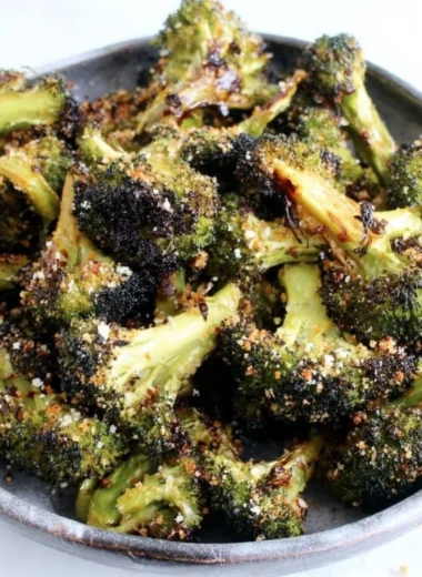Delicious roasted broccoli served on a plate with seasoning