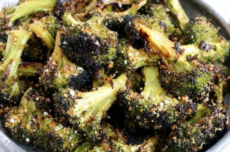 Delicious roasted broccoli served on a plate with seasoning