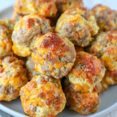 Plate of golden Bisquick sausage balls ready to be served