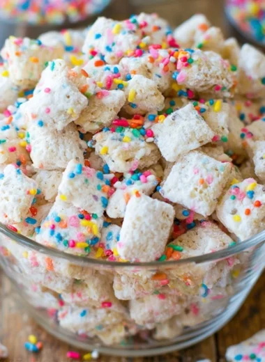 Delicious Cake Batter Puppy Chow in a bowl with colorful sprinkles