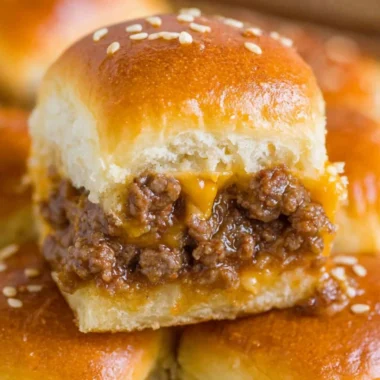 Savory cheeseburger sliders served with toppings on a platter.