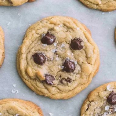 Freshly baked crispy and chewy chocolate chip cookies on a cooling rack