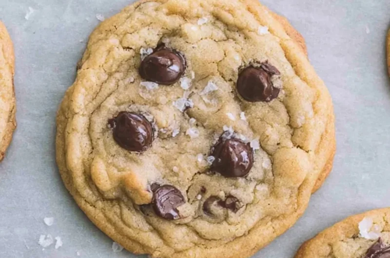 Freshly baked crispy and chewy chocolate chip cookies on a cooling rack