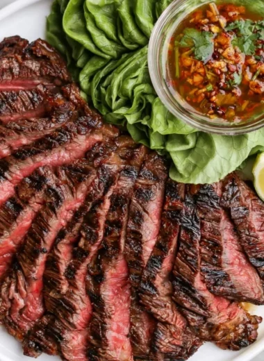 Dish of Crying Tiger Beef garnished with fresh herbs and spices