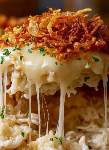 Delicious plate of French Onion Chicken Rice topped with melted cheese and herbs.