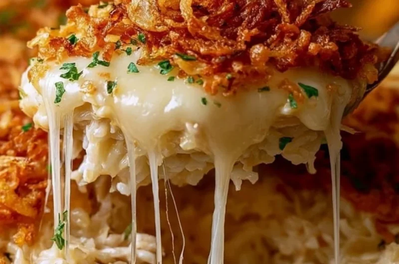 Delicious plate of French Onion Chicken Rice topped with melted cheese and herbs.