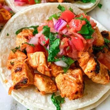 Delicious grilled chicken street tacos with colorful toppings and fresh ingredients.