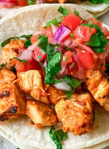 Delicious grilled chicken street tacos with colorful toppings and fresh ingredients.