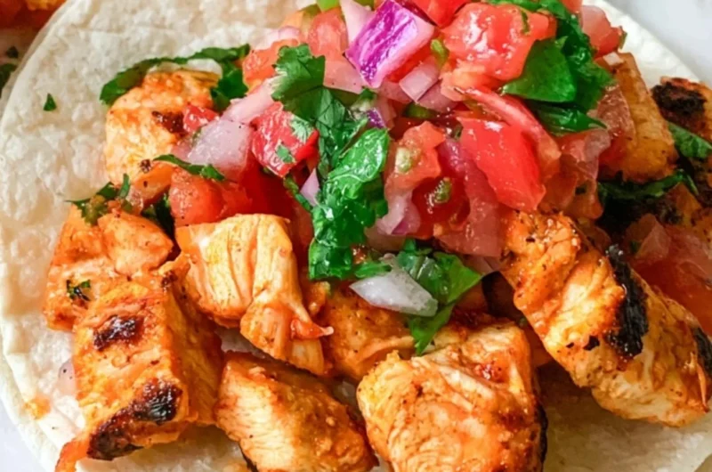 Delicious grilled chicken street tacos with colorful toppings and fresh ingredients.