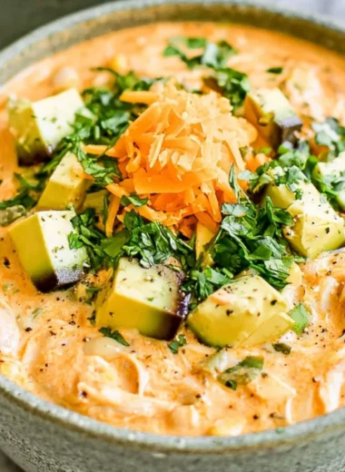 Healthy high protein white chicken chili served in a bowl with fresh toppings