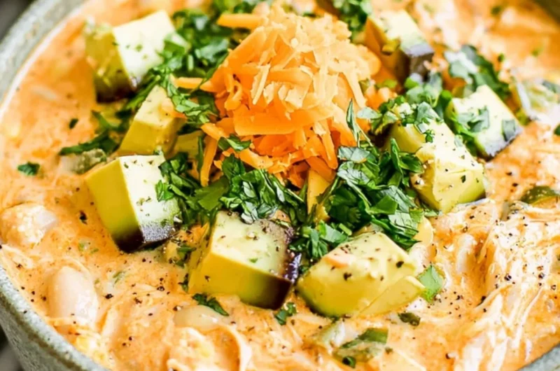 Healthy high protein white chicken chili served in a bowl with fresh toppings
