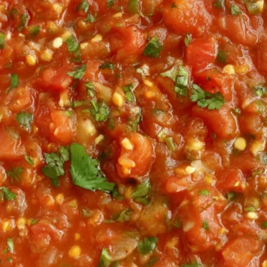 A bowl of vibrant homemade smoked salsa with fresh ingredients and smoky flavor.