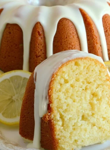 Slice of Italian lemon pound cake on a plate with lemon slices