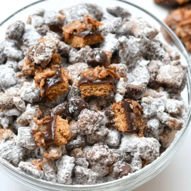 Delicious Samoas Puppy Chow snack in a bowl, featuring chocolate and coconut.