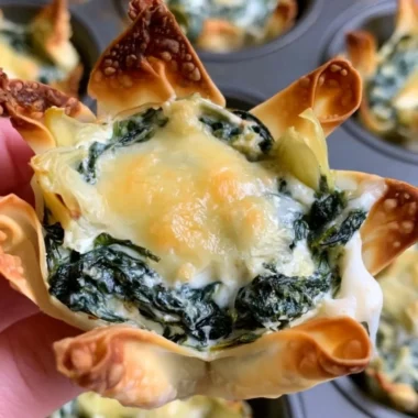 Baked spinach and artichoke wonton cups filled with creamy mixture