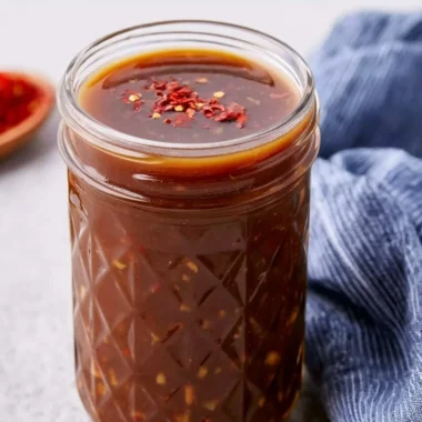 Healthy homemade stir fry sauce in a bowl with vegetables and ingredients