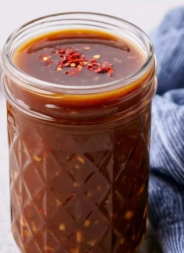 Healthy homemade stir fry sauce in a bowl with vegetables and ingredients