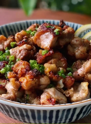 Delicious Yakitori-Inspired Salt and Pepper Chicken Bites on a wooden platter.