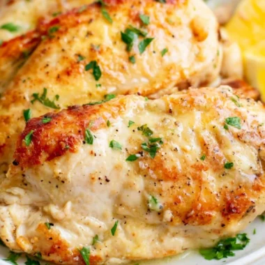 Juicy chicken breasts cooked in an air fryer, served on a plate.