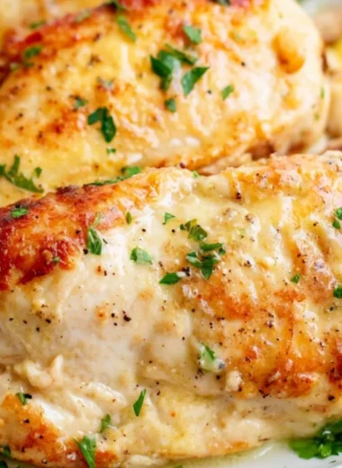 Juicy chicken breasts cooked in an air fryer, served on a plate.