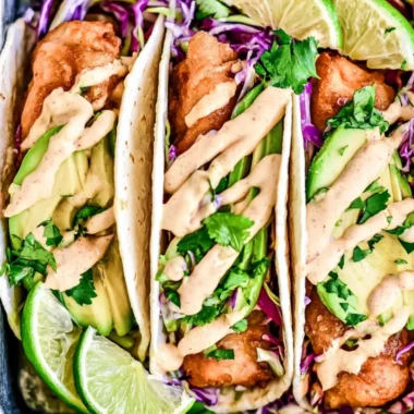 Delicious Baja Fish Tacos served with fresh toppings and lime.