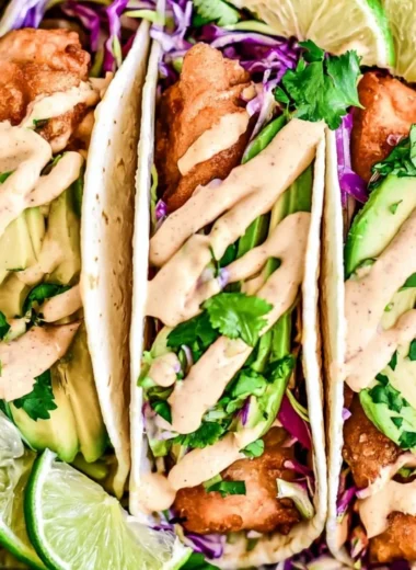 Delicious Baja Fish Tacos served with fresh toppings and lime.
