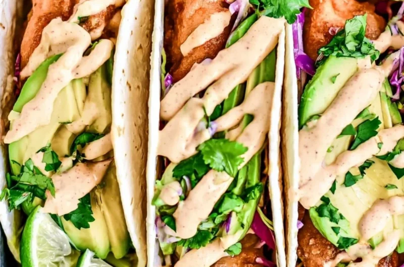 Delicious Baja Fish Tacos served with fresh toppings and lime.
