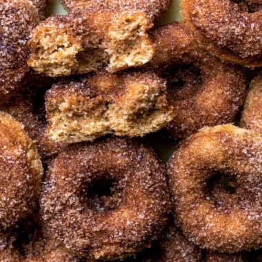 Freshly baked apple cider donuts drizzled with cinnamon glaze