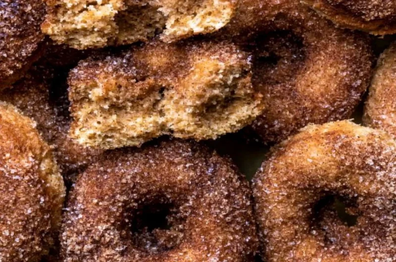Freshly baked apple cider donuts drizzled with cinnamon glaze