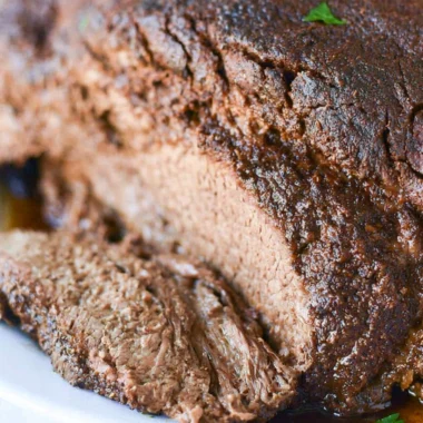 Deliciously cooked classic beef brisket on a wooden cutting board.