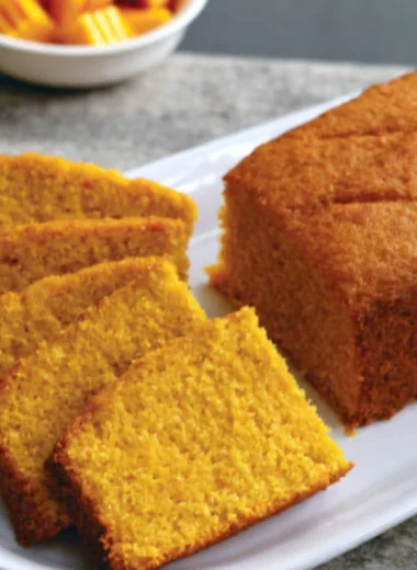 Slice of classic mango cake with fresh mango topping