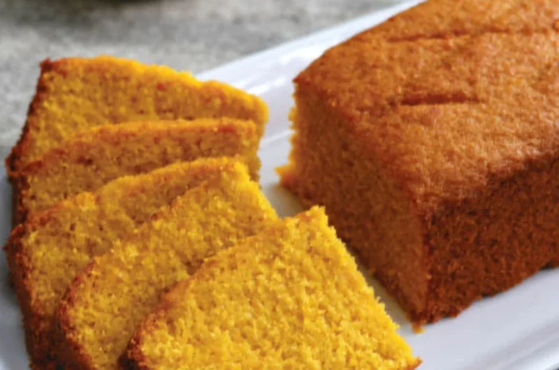 Slice of classic mango cake with fresh mango topping