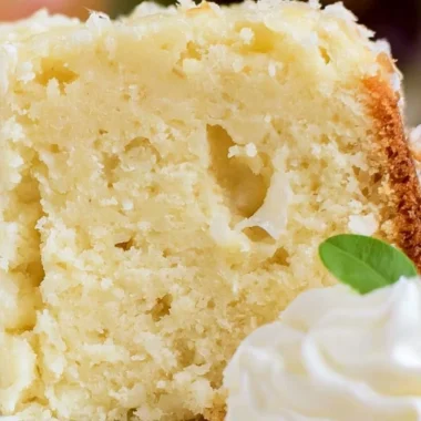 Sliced Coconut Cream Cheese Pound Cake with a tropical garnish