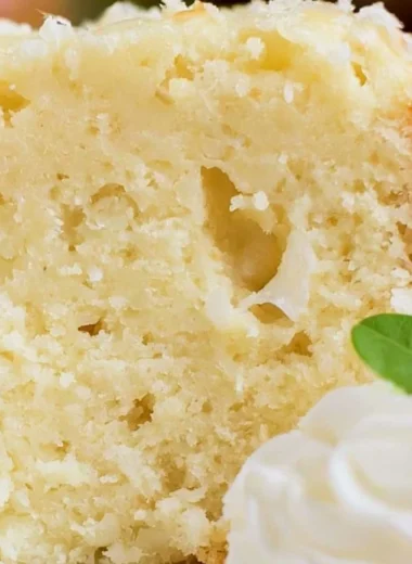 Sliced Coconut Cream Cheese Pound Cake with a tropical garnish