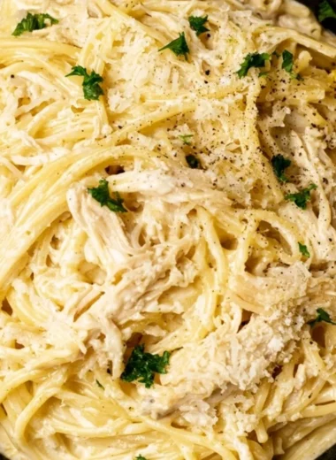 A delicious plate of creamy lemon chicken pasta garnished with herbs