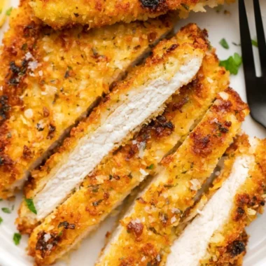 Crispy Parmesan Chicken Cutlets served on a plate with garnish.