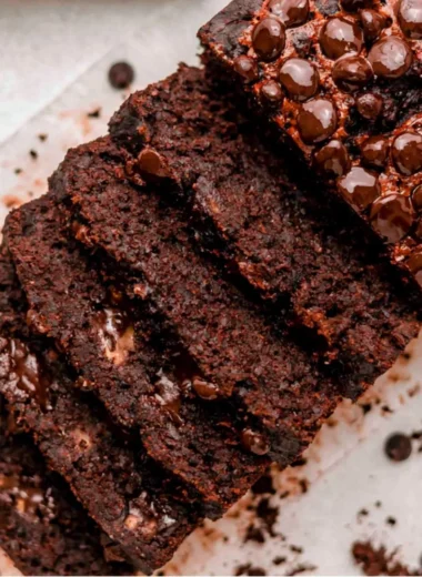 Slice of Double Chocolate Banana Bread on a plate with chocolate chunks