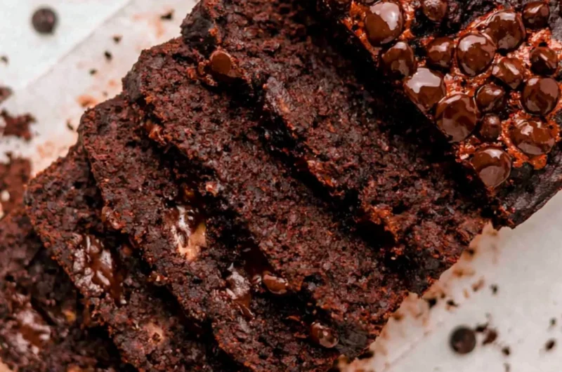 Slice of Double Chocolate Banana Bread on a plate with chocolate chunks