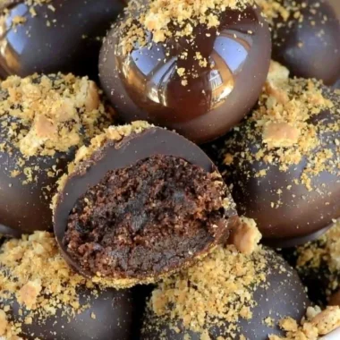 Homemade easy chocolate truffles on a plate with cocoa powder
