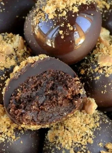 Homemade easy chocolate truffles on a plate with cocoa powder