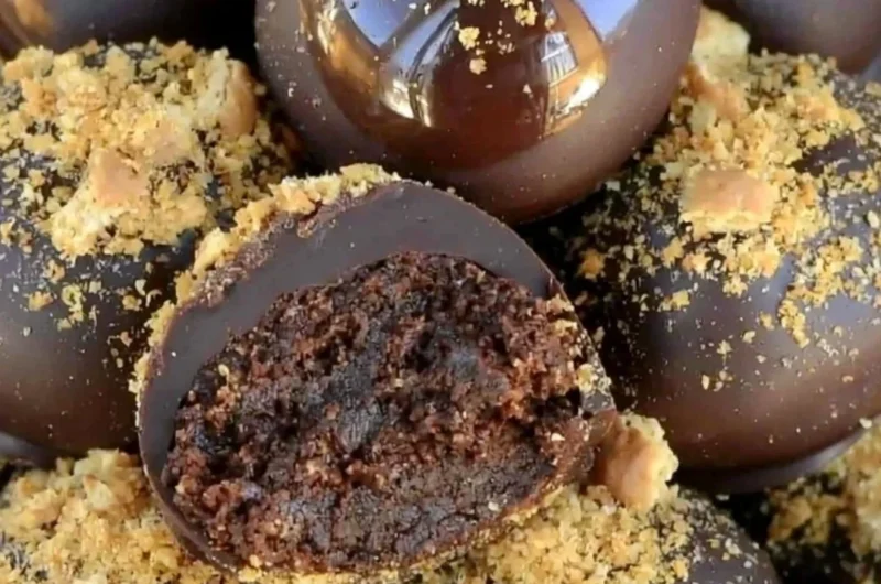 Homemade easy chocolate truffles on a plate with cocoa powder